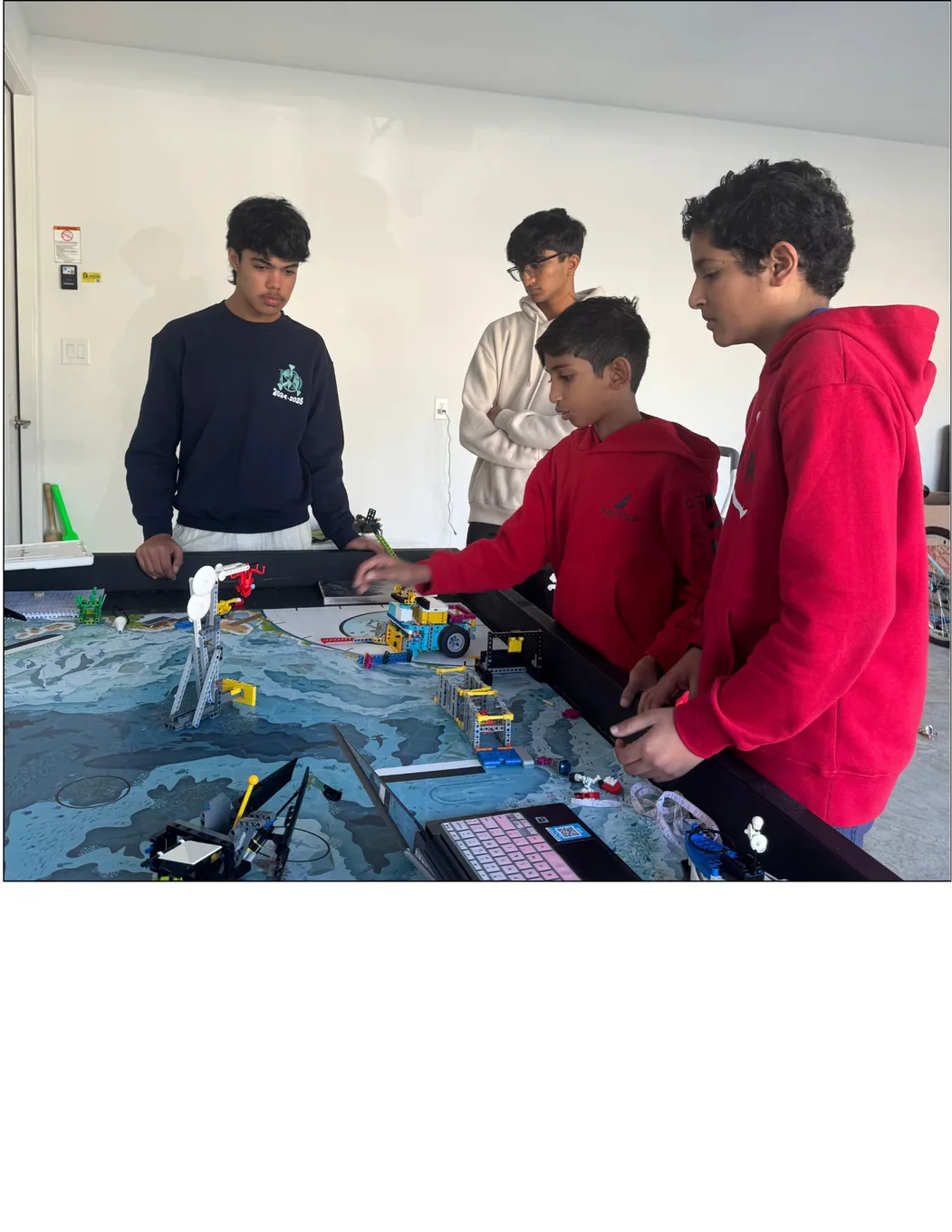 Mentoring students at an FLL practice field