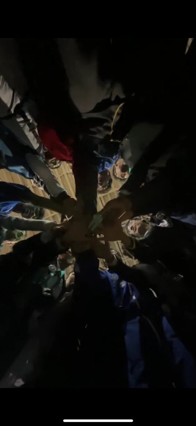 Teammates circle together before competition