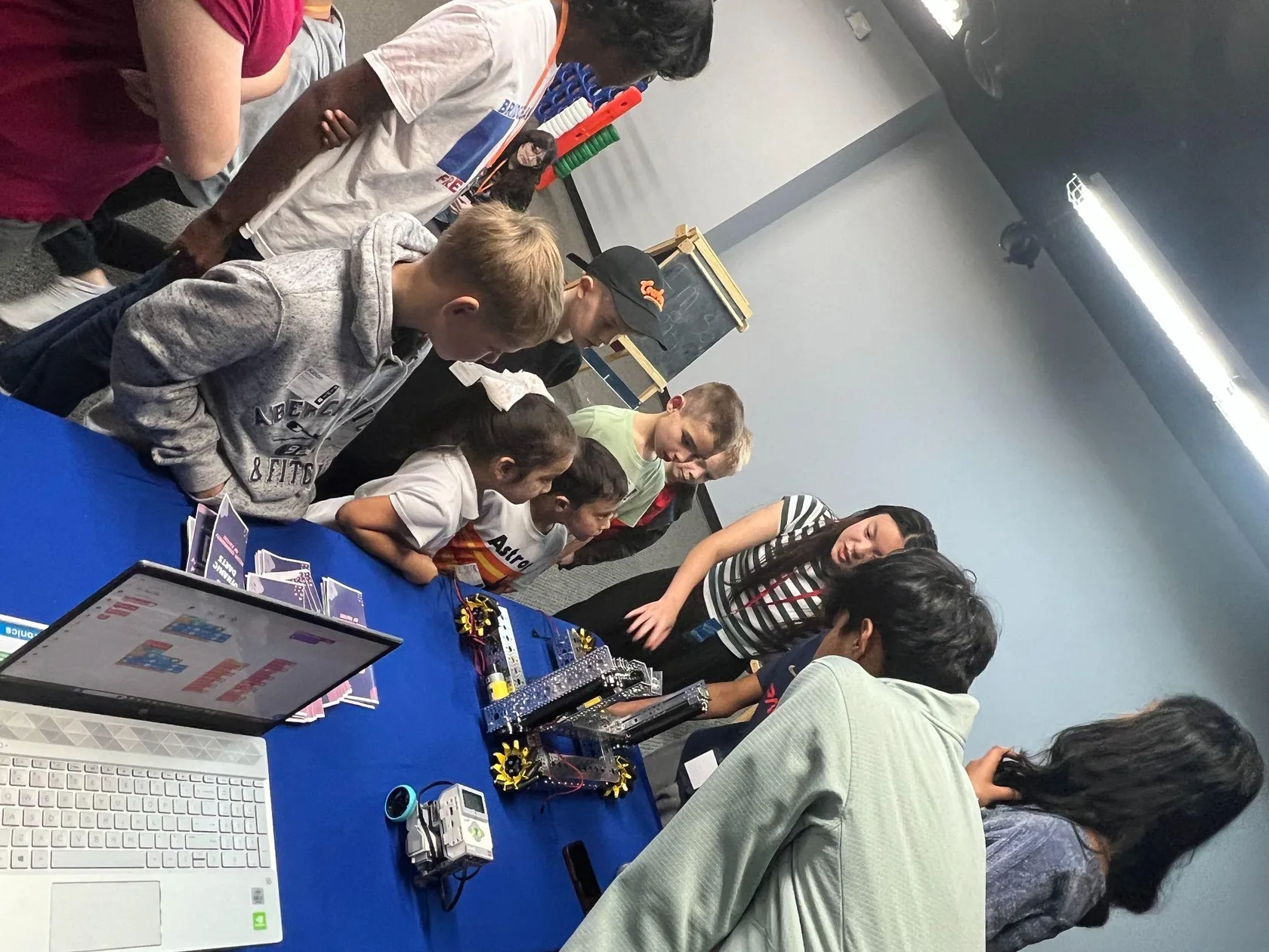 Children looking at a robot during a robotics class